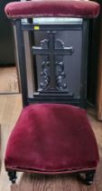 A prayer chair with burgundy velvet upholstery