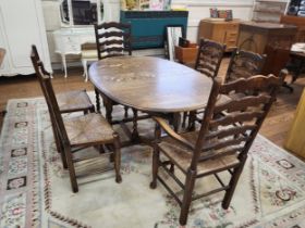 An oak oval drop leaf dining table with barley twist legs and six matching dining chairs, ladder