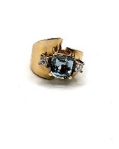 A 14k yellow gold, diamond and aquamarine ring, set with a cushion-cut aquamarine,