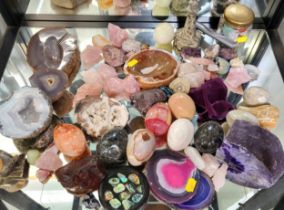 A group of various rocks and minerals, including agates, quartzes, and onyx, some carved, some