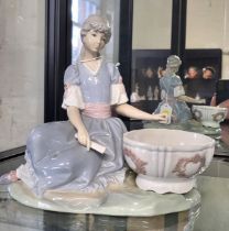 Lladro figure of a girl seated with a basin. 20cm wide