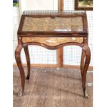 A Theodore Alexander eglomise desk with cabriole legs and brass finials, and a crafted brass gallery