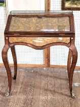 A Theodore Alexander eglomise desk with cabriole legs and brass finials, and a crafted brass gallery