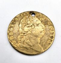A George III half guinea, dated 1798, drilled for a pendant.