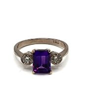 An 18ct white gold, diamond, and amethyst three stone ring, set with a rectangular-cut amethyst