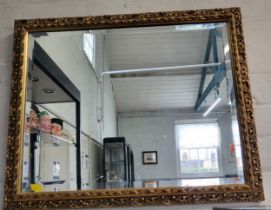 A gilt framed wall or over mantle mirror, 45cm x 58cm