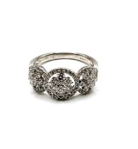 An 18ct white gold and diamond triple cluster ring the diamonds of approximately 1.0 carats combined
