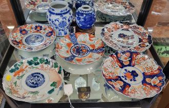 Five Japanese Imari and Arita dishes 21cm to 25cm diameter, a blue and white vase 14cm, and a blue