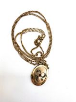 A 9ct yellow gold flattened curb link chain, suspended a late 19th /early 20th century plated locket