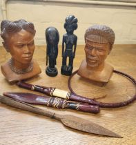 Two carved tribal busts, two carved tribal figures and assorted tribal daggers.