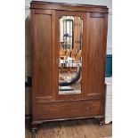 A 20th century mahogany mirrored-door wardrobe, with central mirror and two side doors, interior