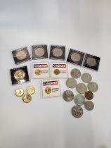 A collection of various coins, within a leatherbound case