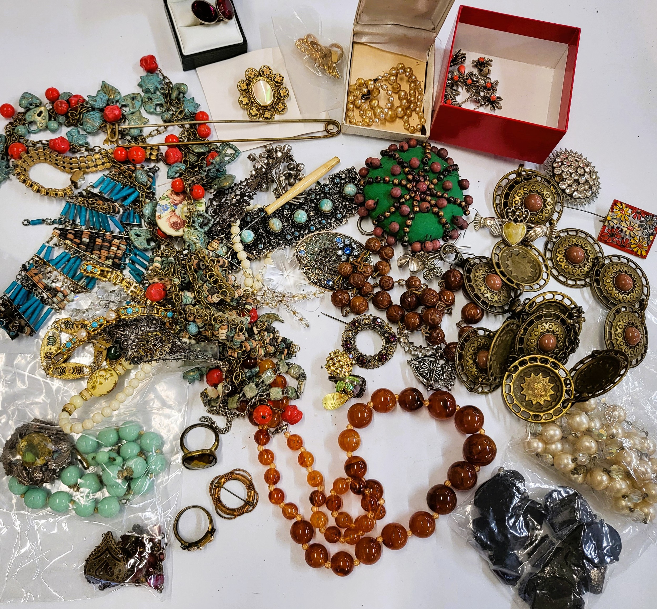 A group of costume jewellery items including two African clay bead necklaces, paste and plastic