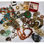 A group of costume jewellery items including two African clay bead necklaces, paste and plastic