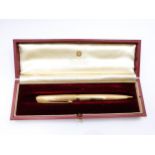 A 9ct yellow gold cased Parker pencil, the engine-turned body with stylised decoration, marked