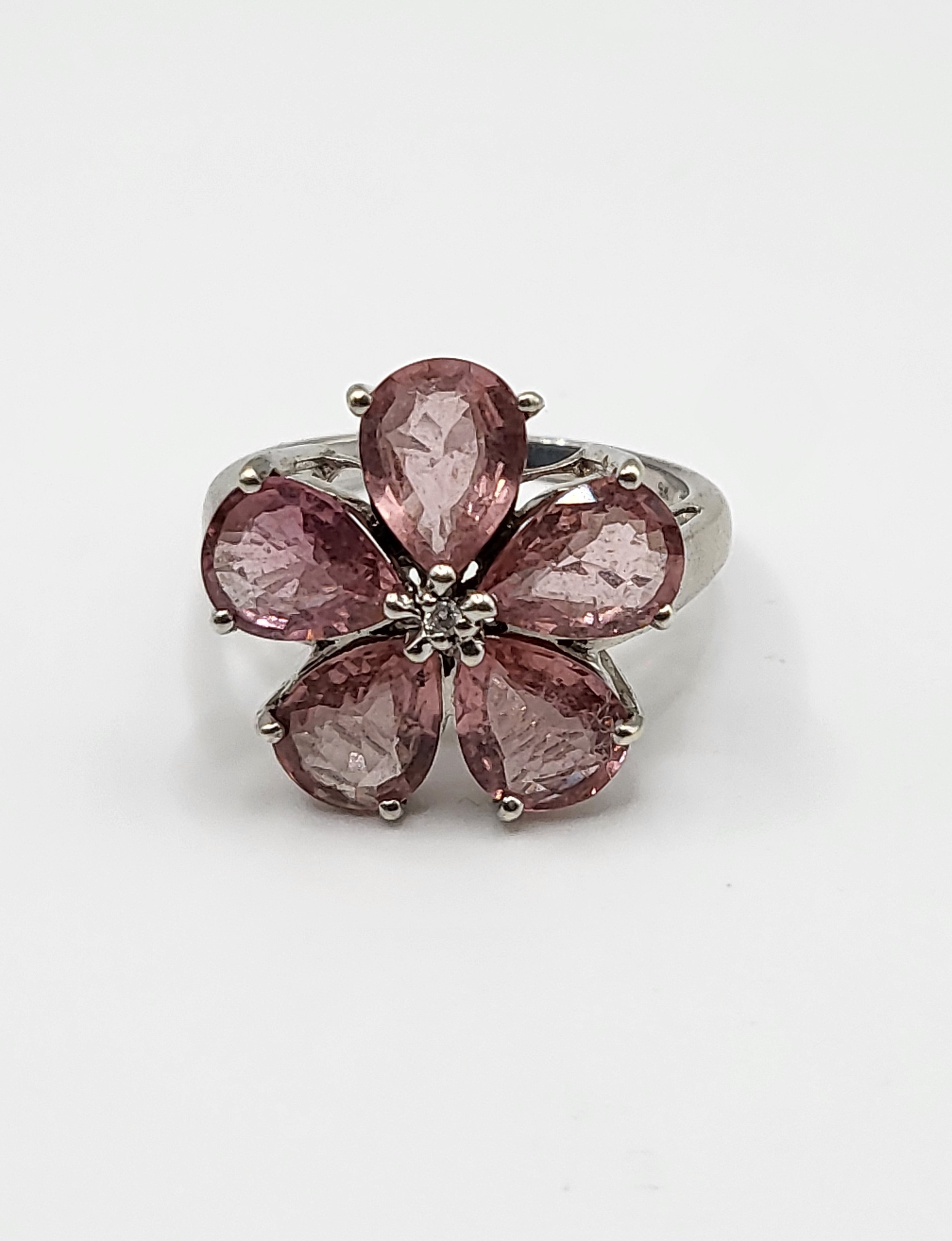 A 9ct white gold and pink tourmaline floral cluster ring, set with five mixed pear-cut petals,