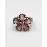 A 9ct white gold and pink tourmaline floral cluster ring, set with five mixed pear-cut petals,