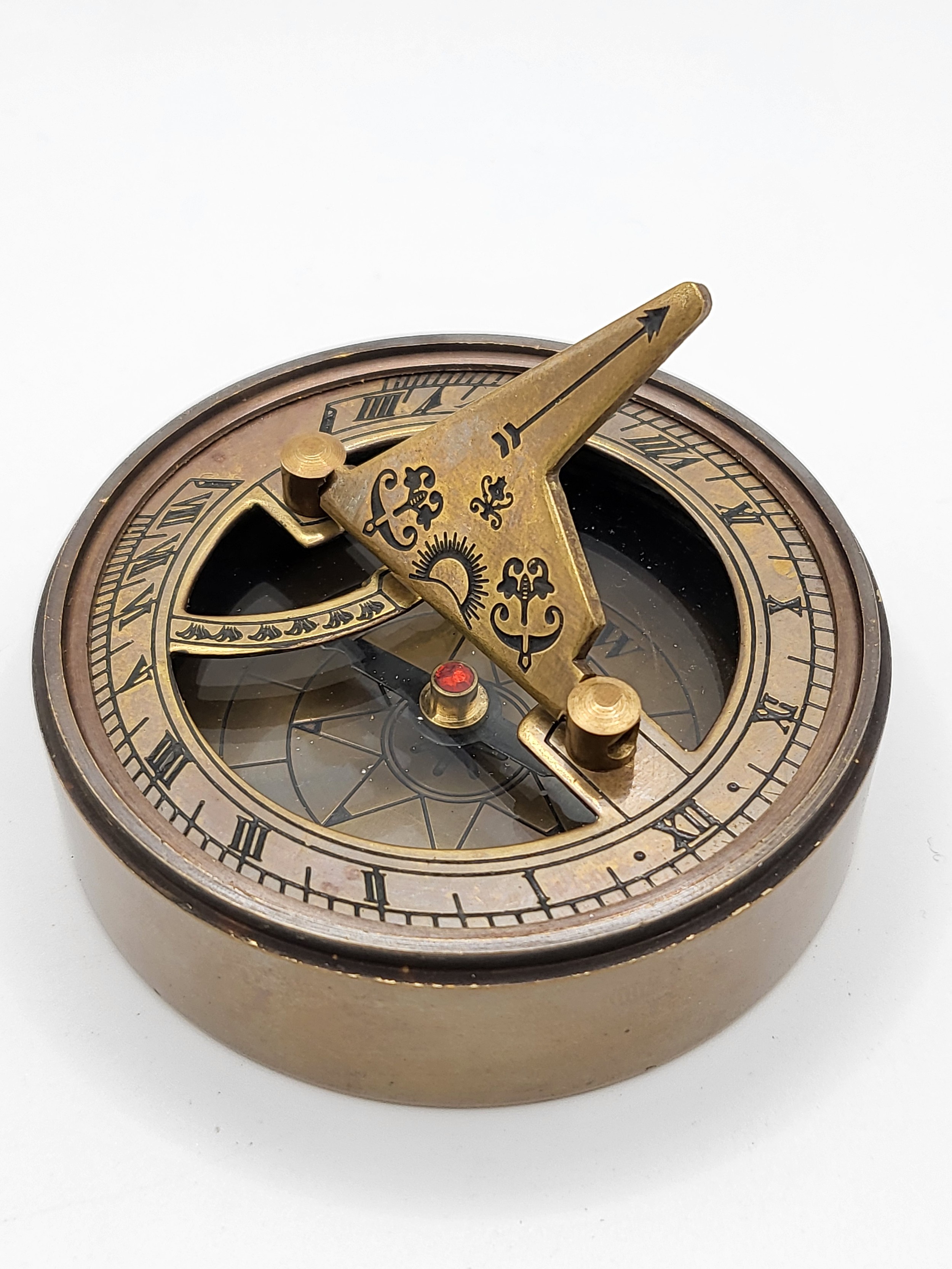A novelty brass-cased sundial and compass.