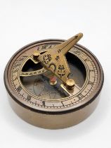 A novelty brass-cased sundial and compass.