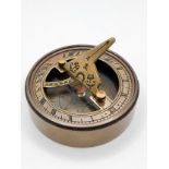 A novelty brass-cased sundial and compass.