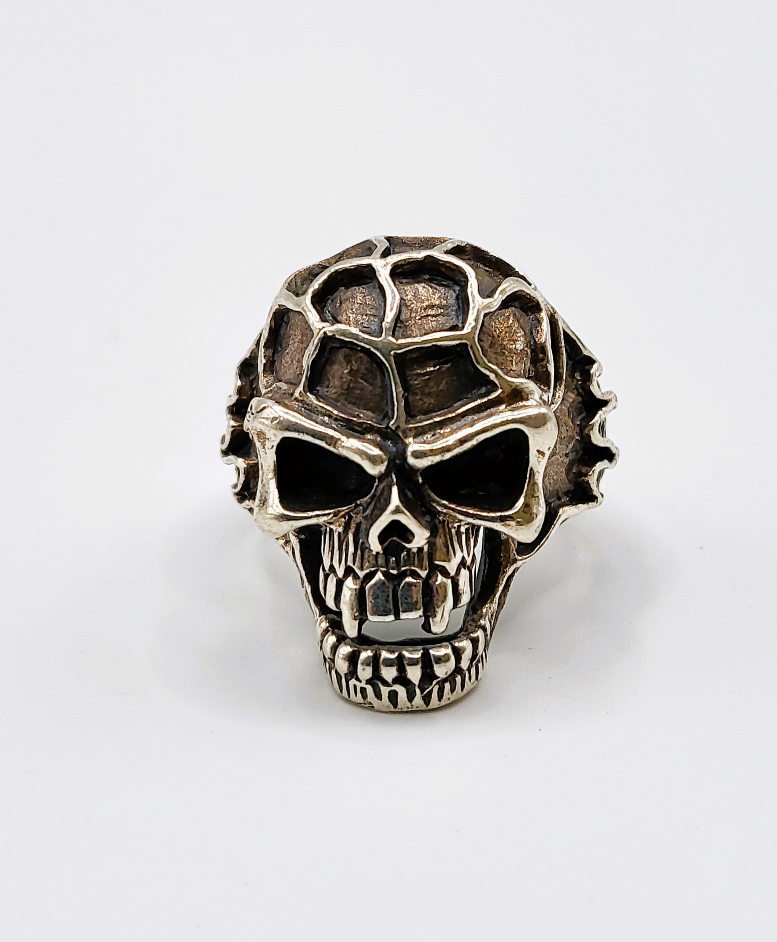 A silver 'knuckleduster' skull ring.