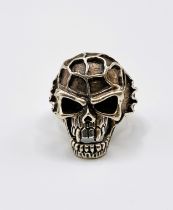 A silver 'knuckleduster' skull ring.