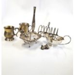 A group of silver plated items, including two mugs, a toast rack, a posy stem vase, and a white