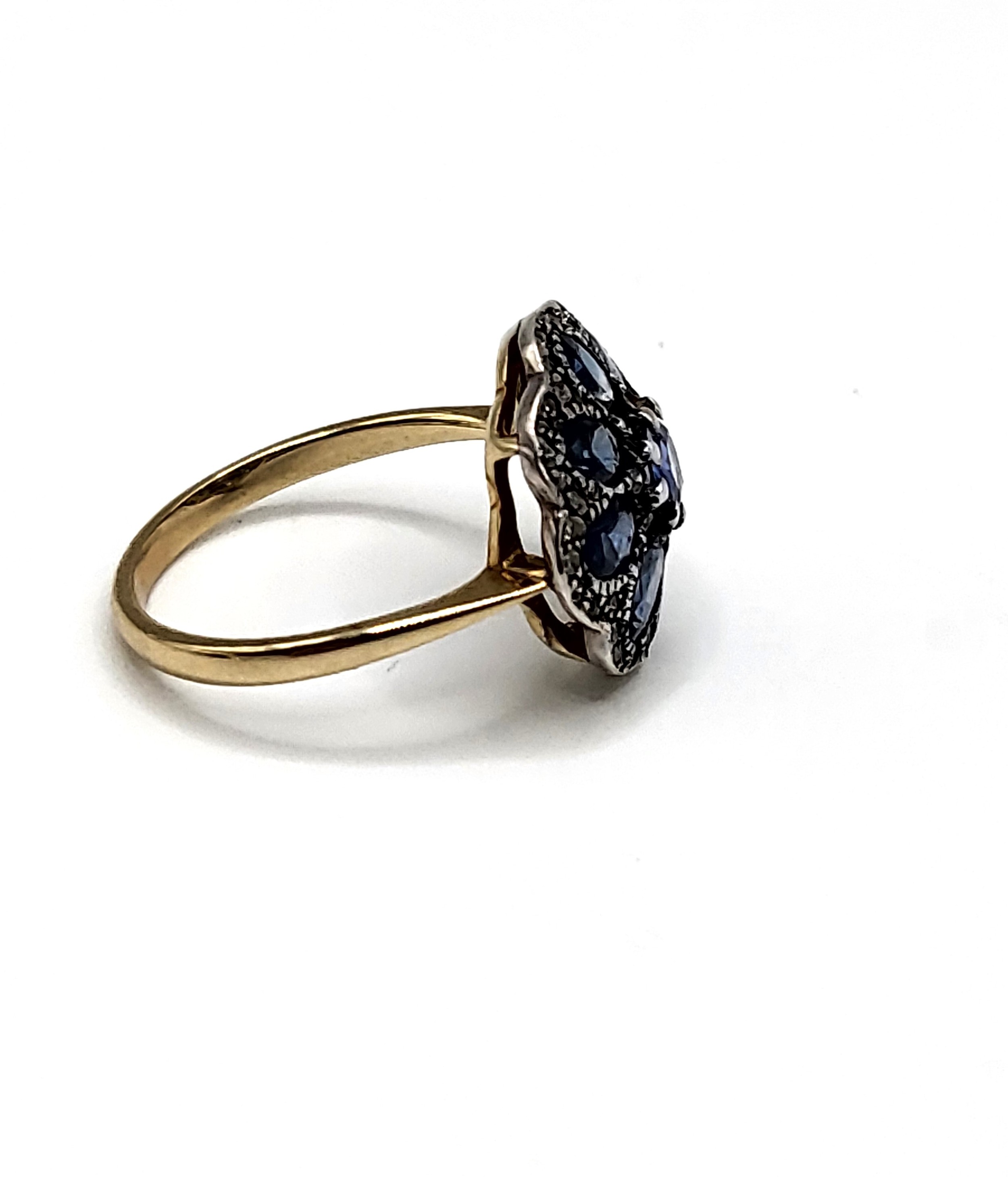 A yellow metal, sapphire, and diamond daisy cluster ring, the silver mount inset with mixed oval and - Image 2 of 3