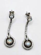 A pair of silver cubic zirconia and opalite drop earrings. (4cm drop, 1.3cm diameter)