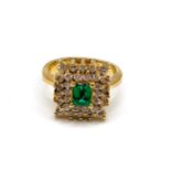 An 18ct yellow gold, diamond, and emerald cluster ring, centred with a mixed emerald-cut emerald,