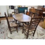 An oak oval drop leaf dining table with barley twist legs and six matching dining chairs, ladder