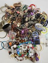 A group of costume jewellery items to include gilt metal and beaded bracelets, necklaces, chains,