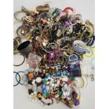 A group of costume jewellery items to include gilt metal and beaded bracelets, necklaces, chains,