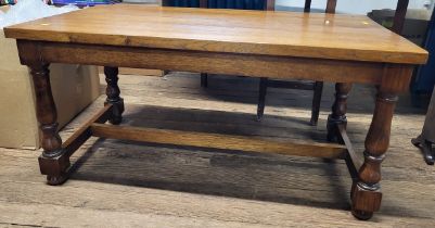 A rectangular oak coffee table, with turned legs and H-stretcher. 49cm x 102cm x 57cm.