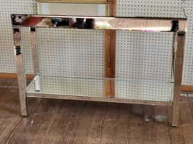 A mirrored console table. 76cm x 112cm x 38cm.