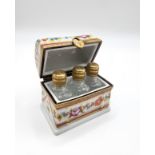 A hand-painted Limoge box, with polychrome decoration, containing three miniature perfume