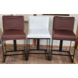 Three tall cream leather stool chairs. Two stools have removable covers as the leather beneath has