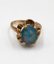 A 9ct yellow gold and triplet opal ring, set with an oval triplet within six claw setting, size O.