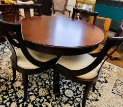 A circular extendable reproduction table and four chairs, table is 112cm with a single center