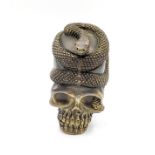 A novelty brass skull vesta case, with a coiled snake. 5.2cm
