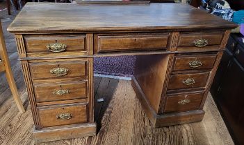 A 20th century wooden twin pedestal desk, fitted with eight drawers, brass handles, plain top.