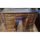 A 20th century wooden twin pedestal desk, fitted with eight drawers, brass handles, plain top.