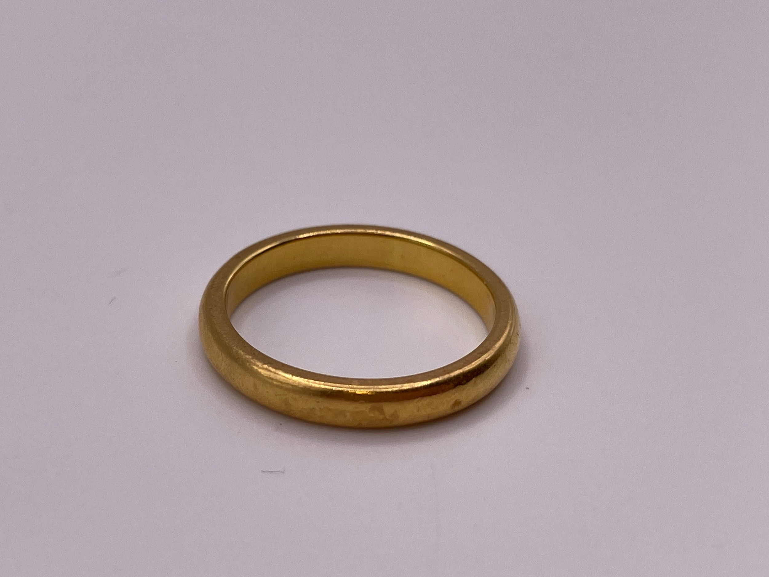 A plain yellow gold wedding band ring, marked 916 to shank, size N.