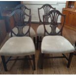 Four Hepplewhite style mahogany dining chairs with overstuffed seats.