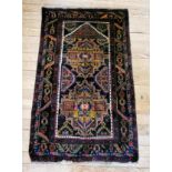 A small 100% wool rug, polychrome design, bordered and fringed.