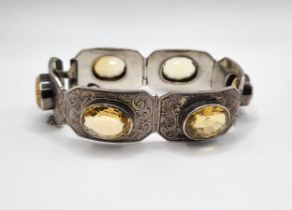 A Victorian silver segmented bracelet, set with six mixed oval-cut citrines, the silver with