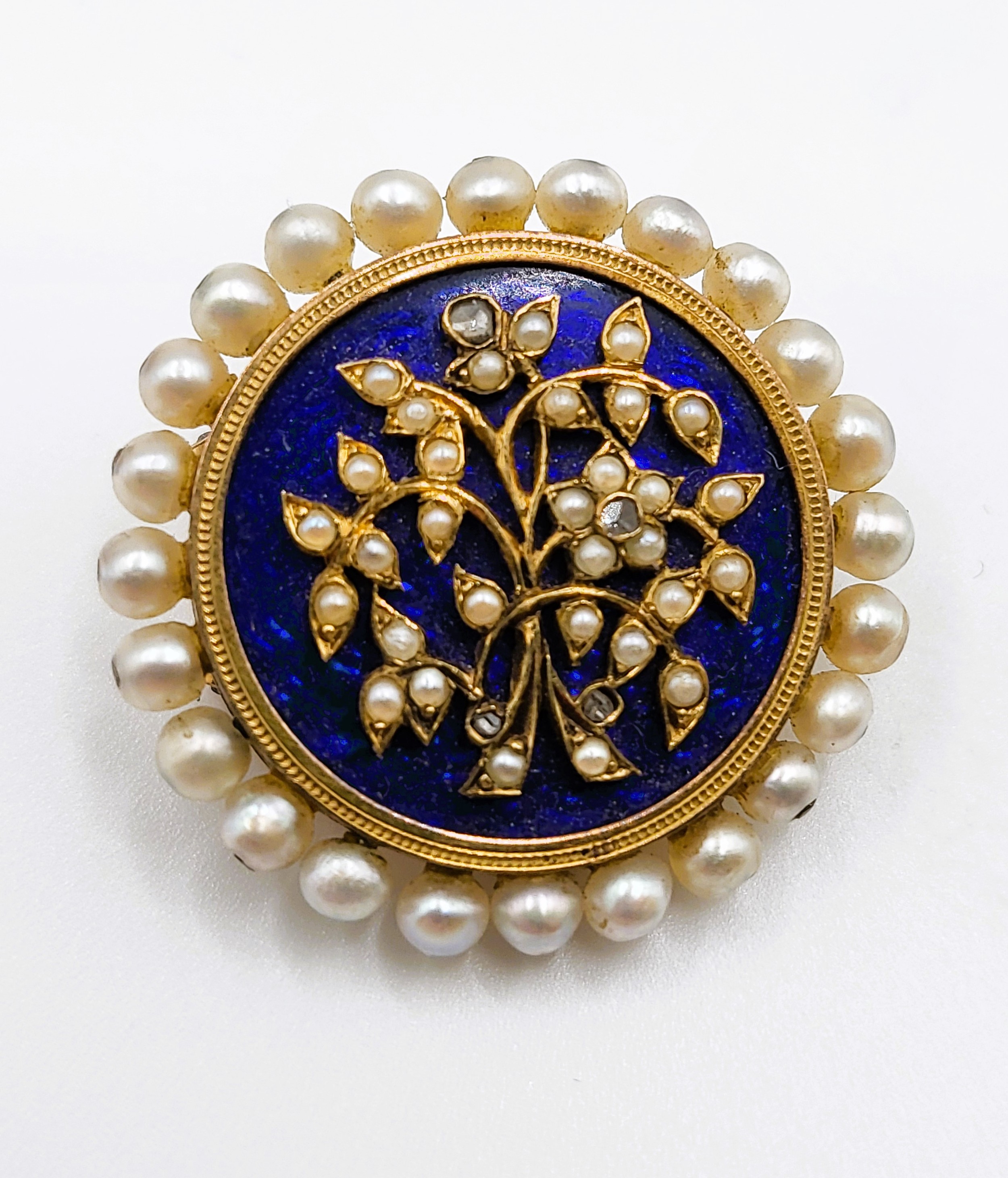 A late 19th century Victorian seed pearl and diamond brooch, of circular form, the cobalt blue