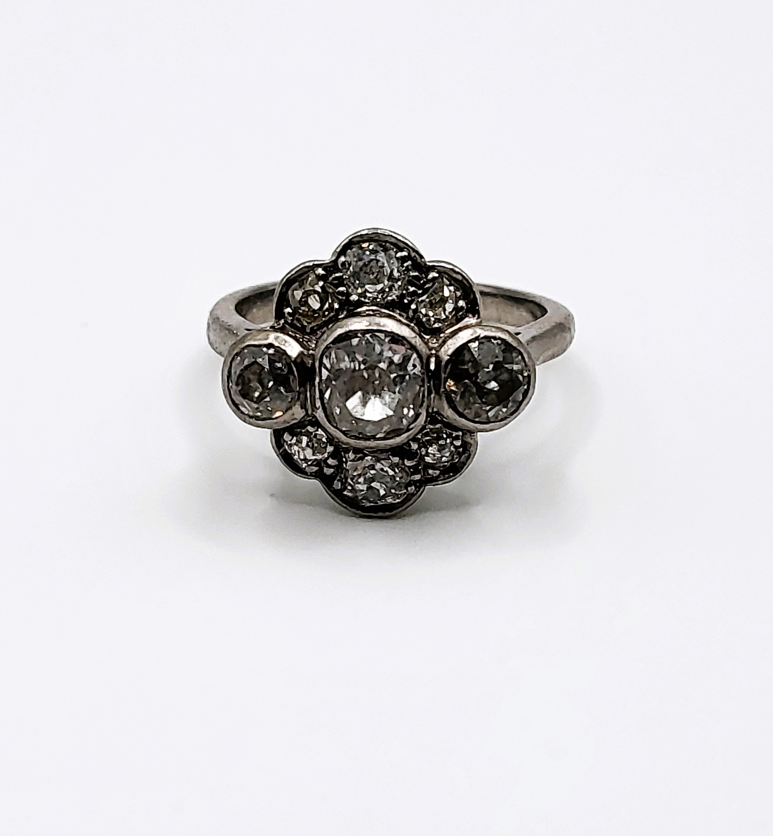 An 18ct white gold flower head-style diamond ring.