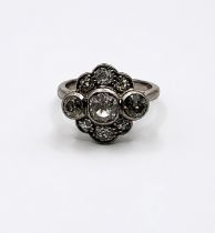 An 18ct white gold flower head-style diamond ring.