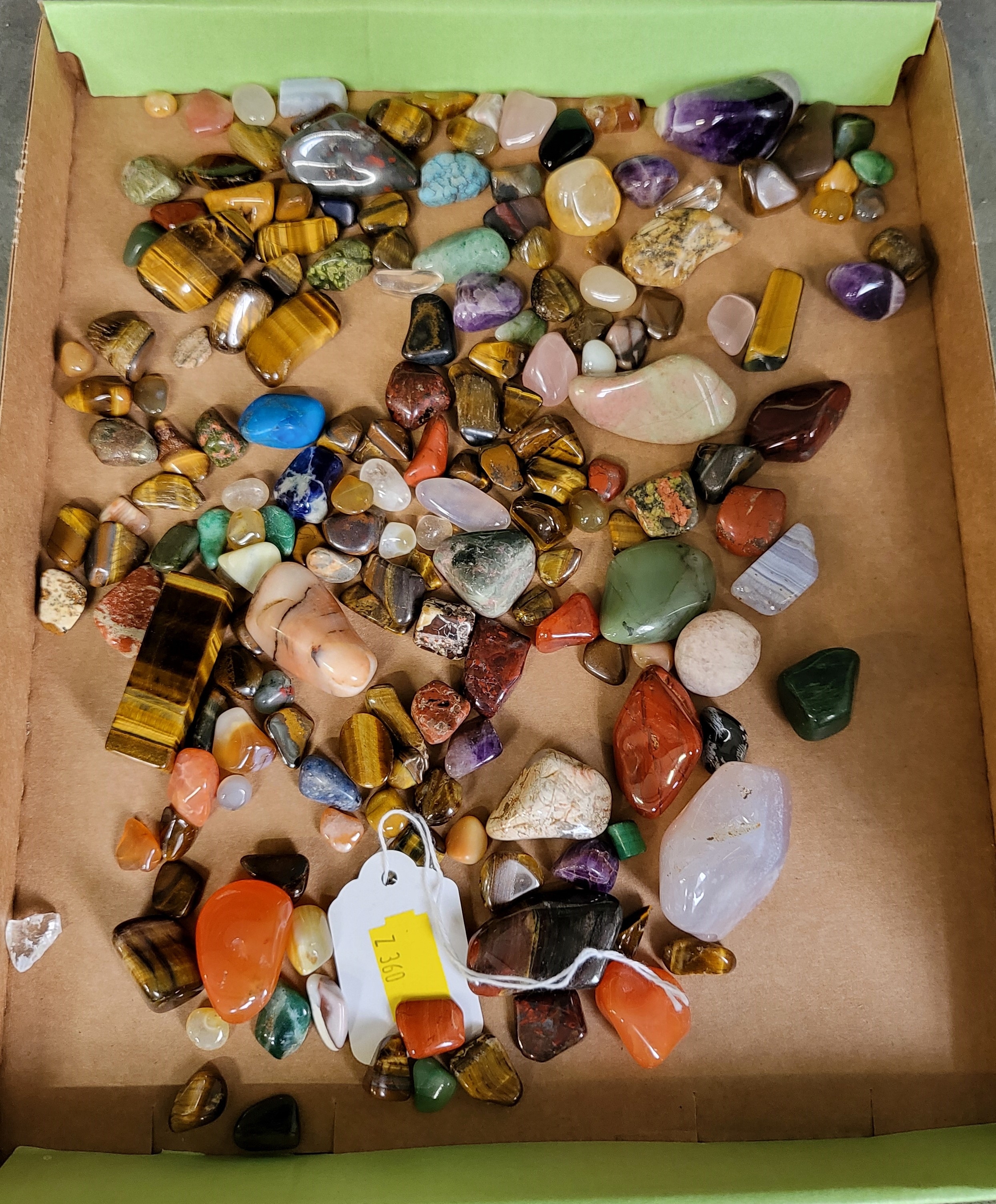 A quantity of various tumbled gemstones, including jasper, tigers eye, amethyst quartz, carnelian,